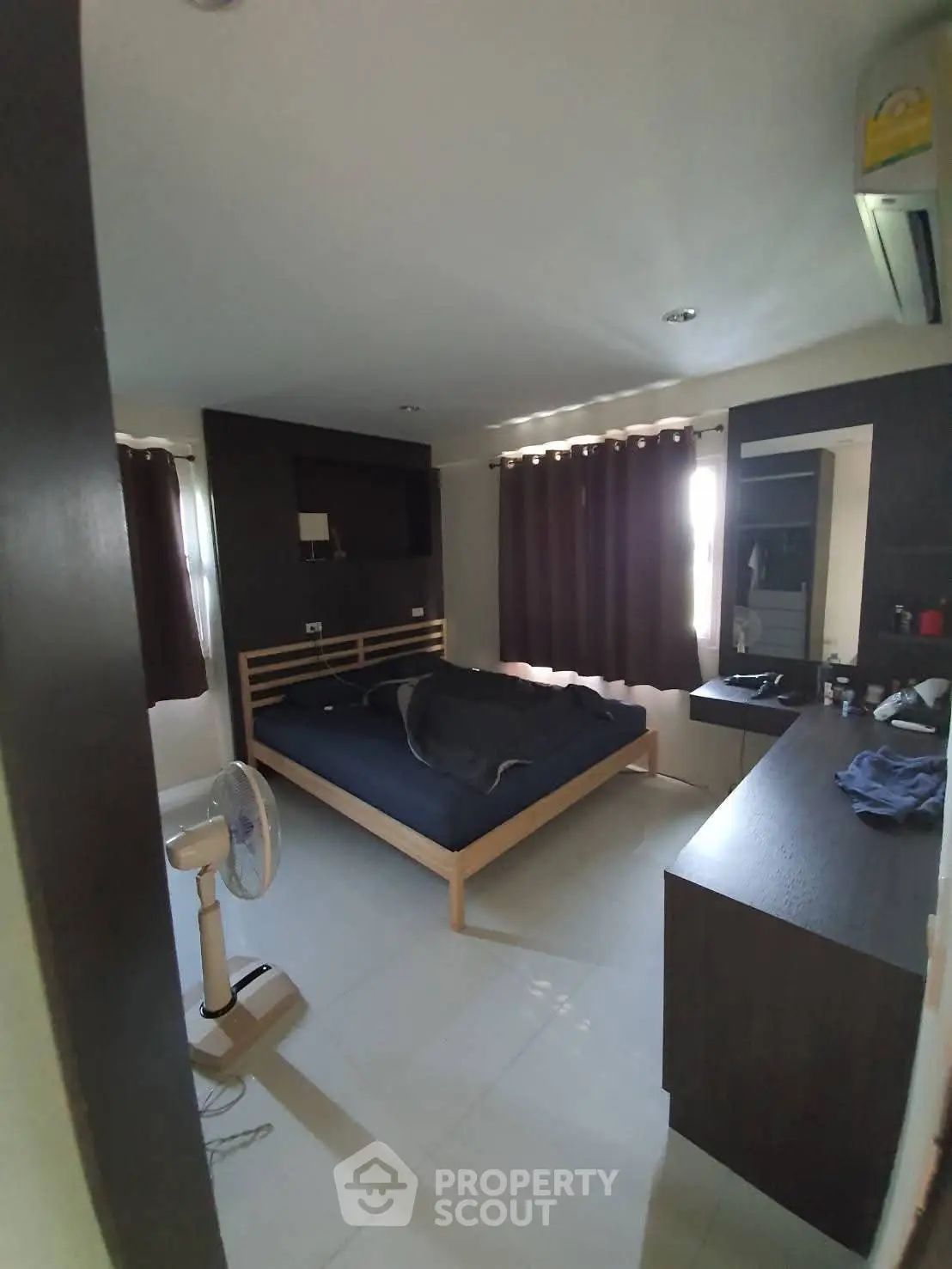 Spacious bedroom with modern furnishings and natural light