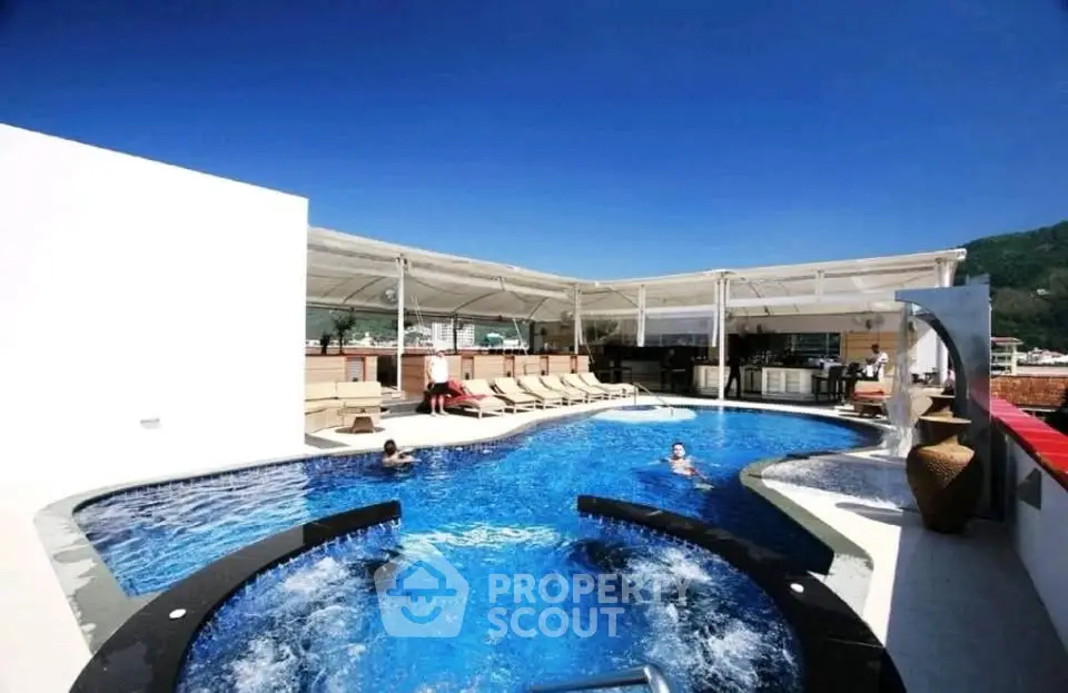 Luxurious rooftop pool with sun loungers and stunning views, perfect for relaxation and entertainment.