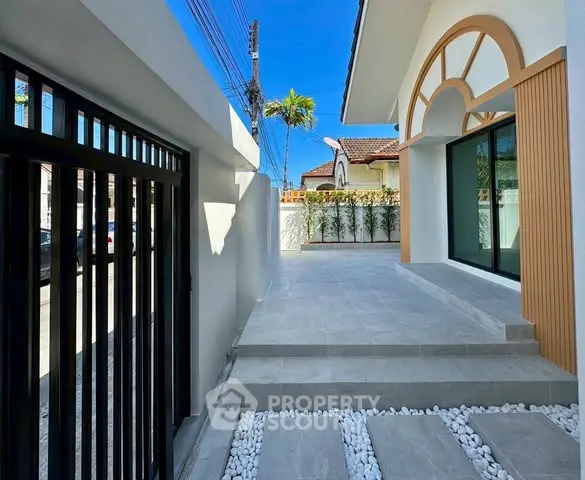 Modern exterior with stylish entrance and sleek design, featuring a spacious patio and elegant architectural details.