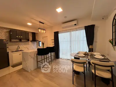 Modern open-layout kitchen and dining area with stylish decor and ample natural light.