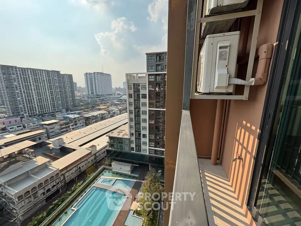 High-rise apartment view with cityscape and pool, showcasing urban living and modern amenities.