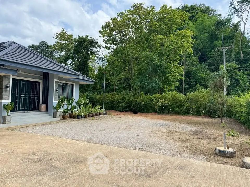 Charming suburban home with lush greenery and spacious driveway, perfect for family living.