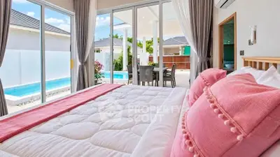 Luxurious bedroom with pool view and elegant decor in modern villa