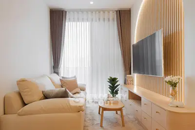 Modern living room with elegant decor, cozy sofa, and stylish TV setup, perfect for relaxation and entertainment.