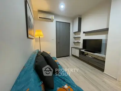 Cozy living room with modern decor and wall-mounted TV, perfect for relaxation.