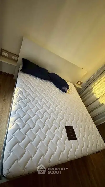 Spacious bedroom with a comfortable bed and natural light, perfect for relaxation.