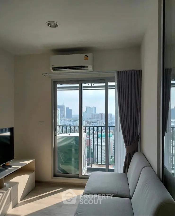 Modern living room with city view, featuring sleek sofa and air conditioning, perfect for urban living.