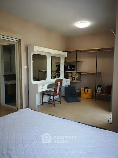 Spacious bedroom with walk-in closet and elegant vanity setup