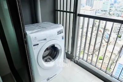 High-rise balcony with washing machine and city view, perfect for urban living convenience.