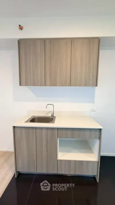 Modern minimalist kitchen with sleek cabinetry and integrated sink