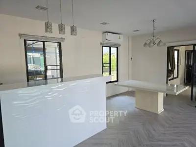 Spacious modern living room with stylish lighting and large windows