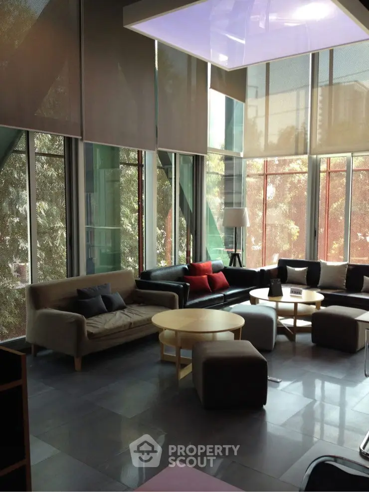 Spacious modern living room with large windows and stylish furniture