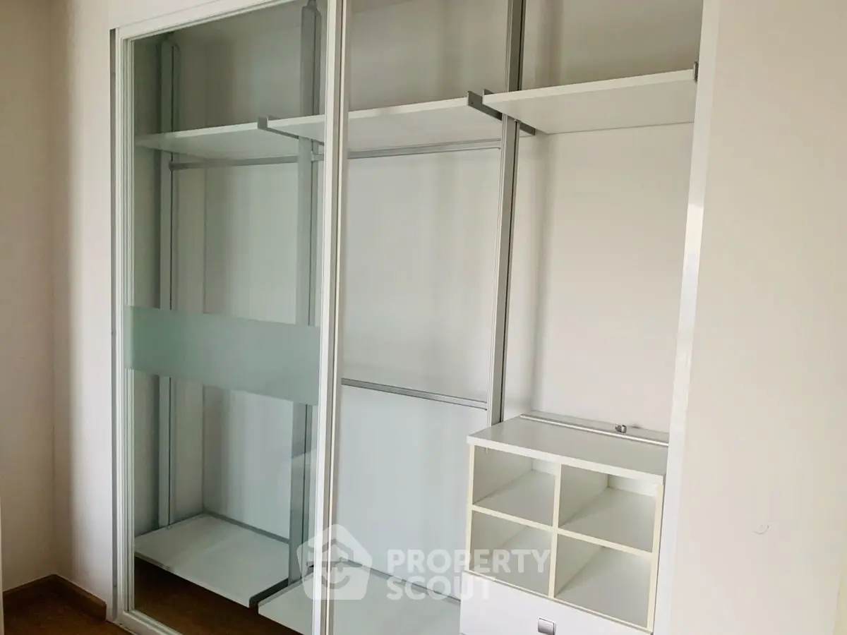 Spacious walk-in closet with modern shelving and storage solutions.