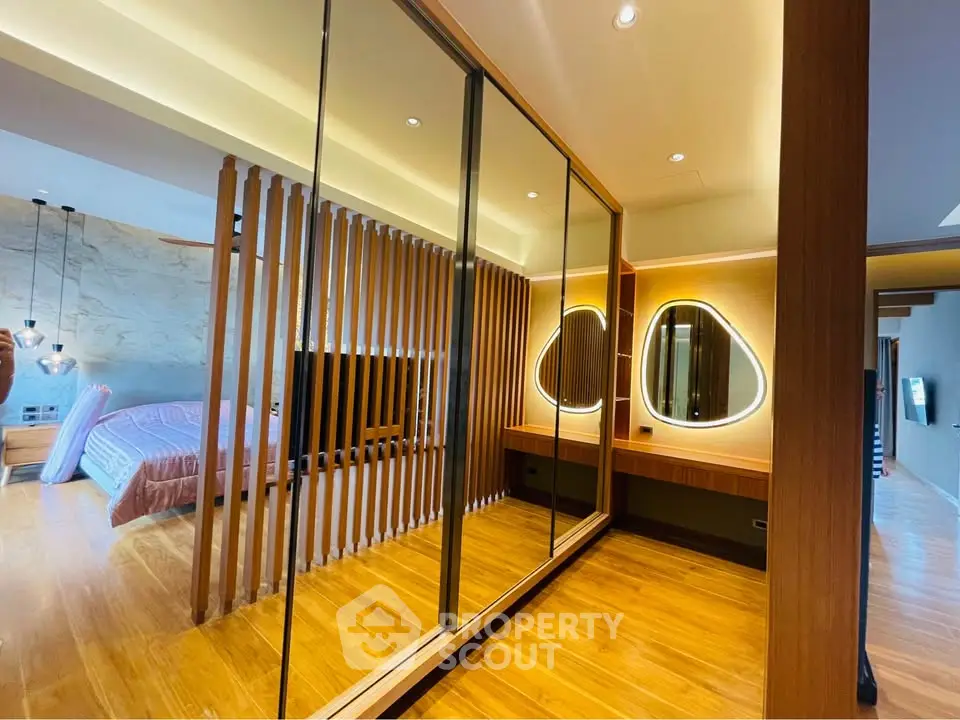 Luxurious modern bedroom with mirrored wardrobe and elegant lighting