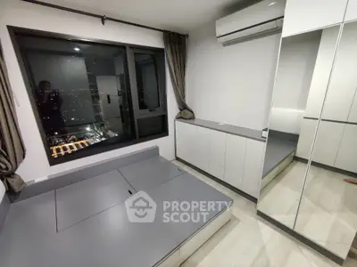 Modern bedroom with city view, mirrored wardrobe, and sleek design