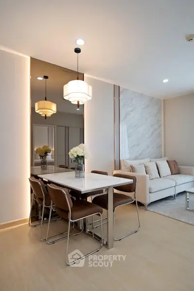 Modern living room with elegant dining area and stylish lighting in a contemporary apartment.