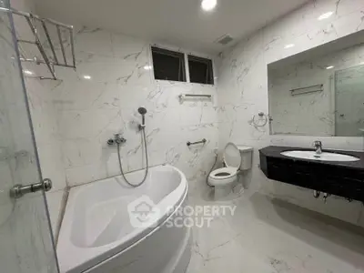 Luxurious marble bathroom with modern fixtures and corner bathtub