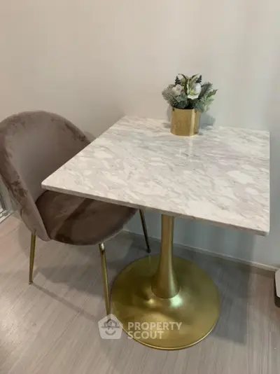 Elegant dining nook with marble table and plush chair