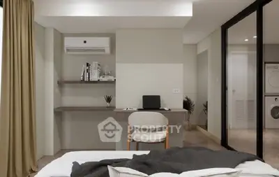 Modern bedroom with study area and in-room laundry facilities.