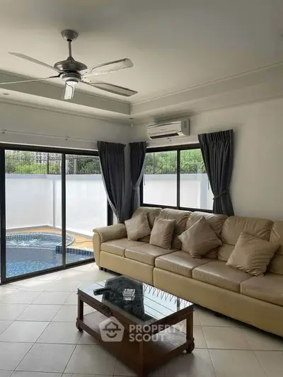 Spacious living room with pool view and modern furnishings