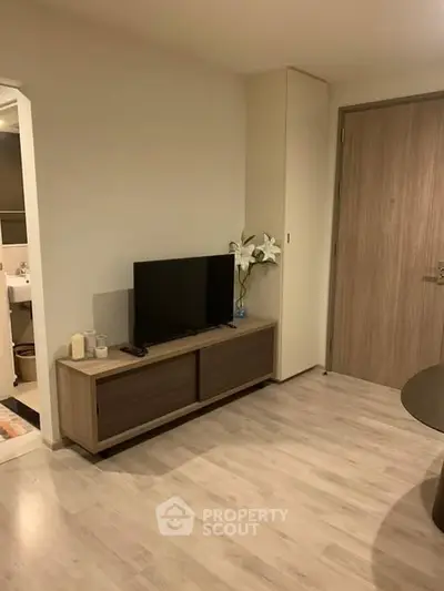 Modern living room with sleek TV stand and wooden flooring