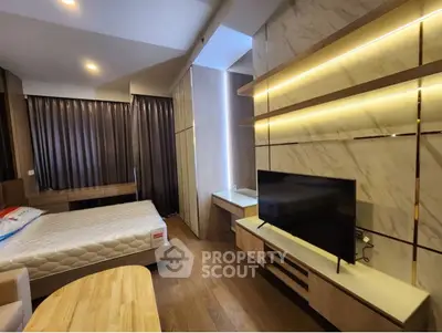 Modern bedroom with sleek design, featuring a large bed, built-in TV unit, and elegant lighting.