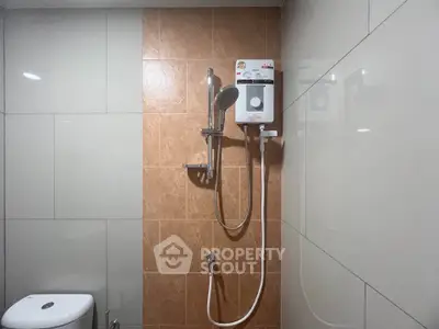 Modern bathroom with sleek shower and neutral tiles
