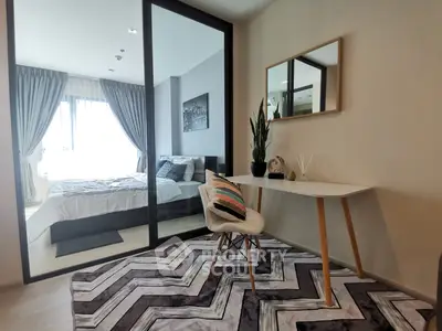 Modern bedroom with stylish study area and large window for natural light.