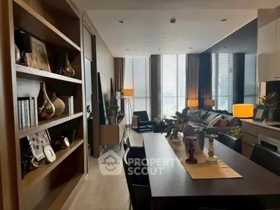 Modern living room with elegant decor and large windows offering natural light.