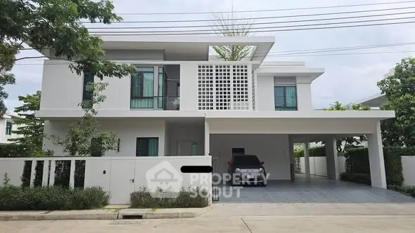 Modern two-story house with sleek design and spacious carport in a serene neighborhood.