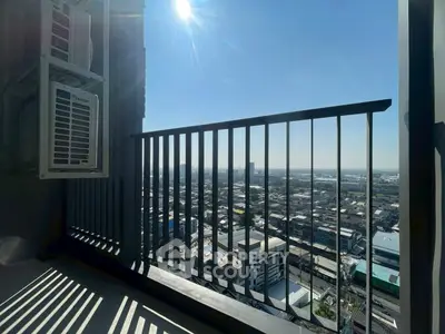 Stunning cityscape view from a high-rise balcony with clear blue skies.