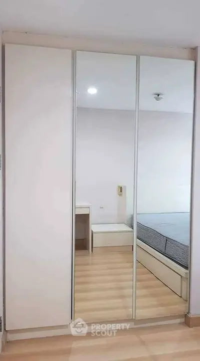 Modern bedroom with mirrored wardrobe and minimalist design