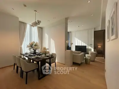 Luxurious open-plan living and dining area with elegant decor and natural light.