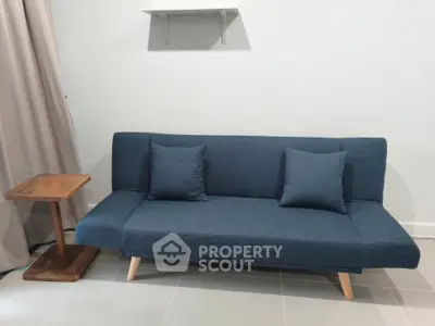 Modern living room with stylish blue sofa and wooden side table