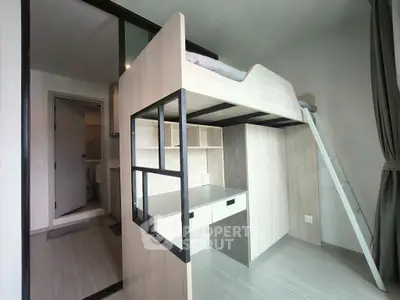Modern loft-style bedroom with integrated study desk and ladder access