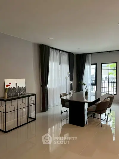 Spacious modern dining area with elegant decor and large windows for natural light.