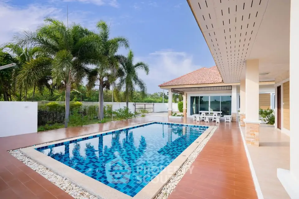 Luxurious villa with private pool and palm trees, perfect for tropical living.