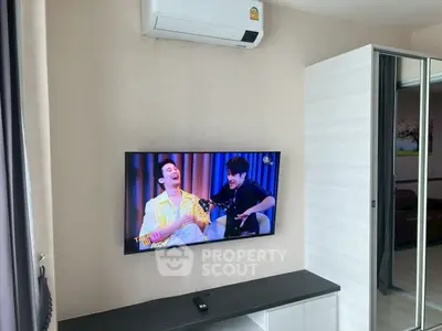 Modern living room with wall-mounted TV and air conditioning unit