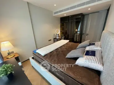 Luxurious bedroom with modern decor and cozy ambiance, featuring elegant bedding and stylish lighting.