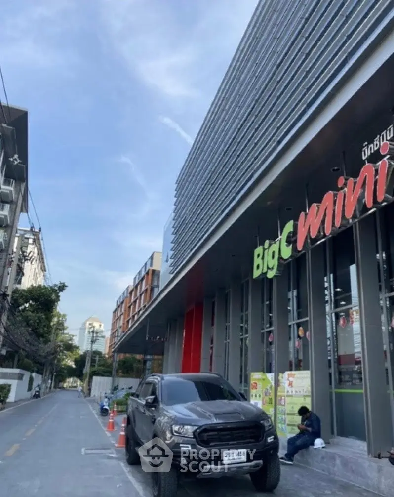 Modern commercial building exterior with Big C Mini signage and street view.