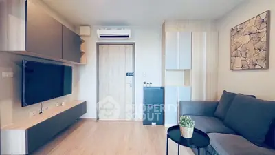 Modern living room with sleek furniture and wall-mounted TV, perfect for urban living.