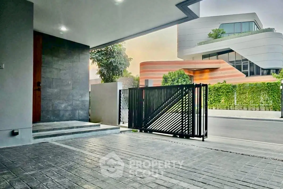 Modern home entrance with sleek gate and contemporary architecture in a stylish neighborhood.