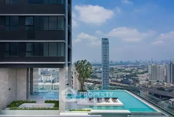 Luxurious high-rise building with stunning rooftop pool and cityscape view.
