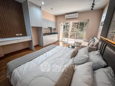 Modern bedroom with balcony, stylish decor, and natural light in a cozy apartment.