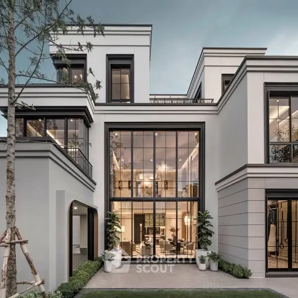 Stunning modern luxury home exterior with large windows and elegant design.