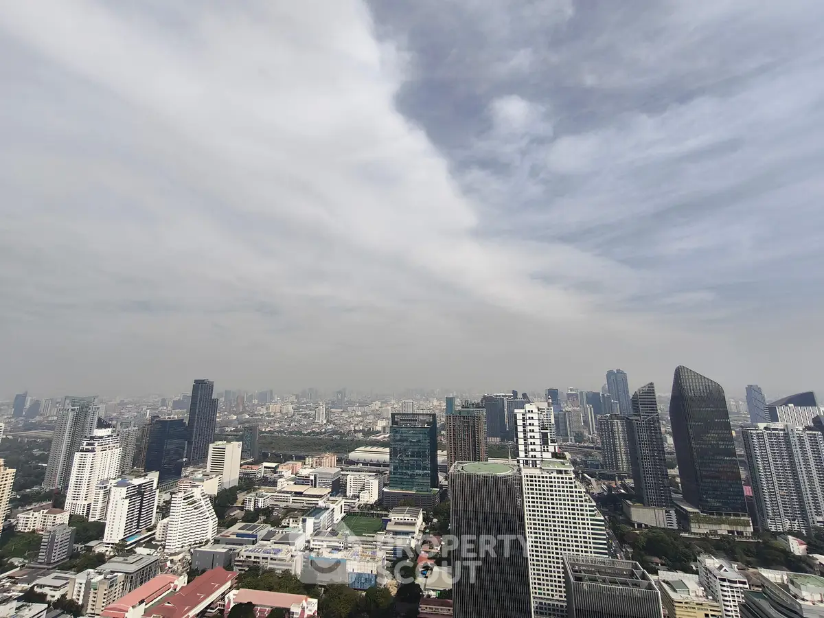 Stunning panoramic cityscape view from a high-rise building showcasing modern architecture and urban skyline.