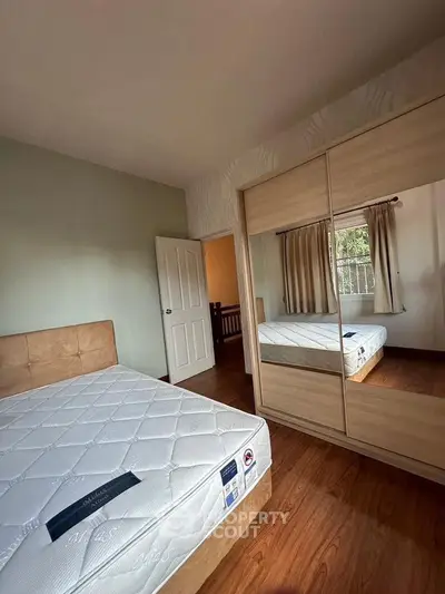 Cozy bedroom with mirrored wardrobe and natural light
