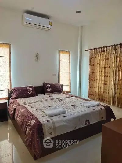 Spacious bedroom with elegant decor and natural light