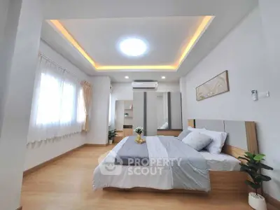 Spacious modern bedroom with elegant lighting and stylish decor