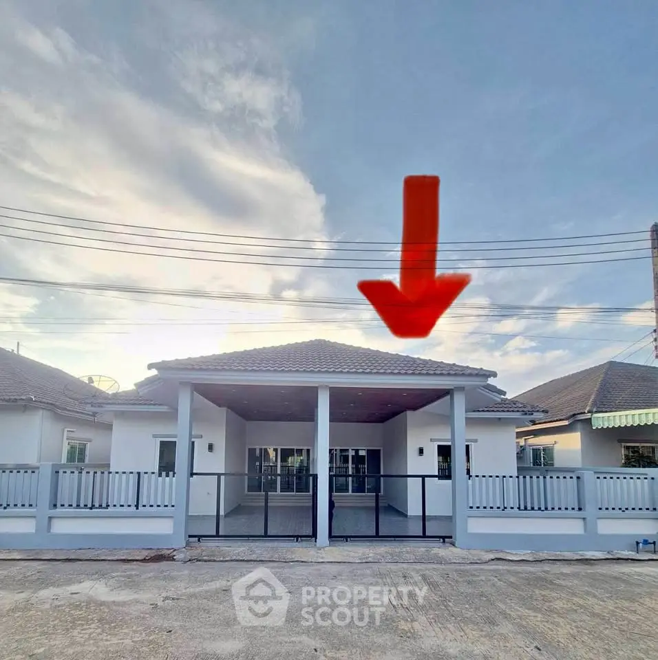 Charming single-story home with spacious driveway and modern exterior design.